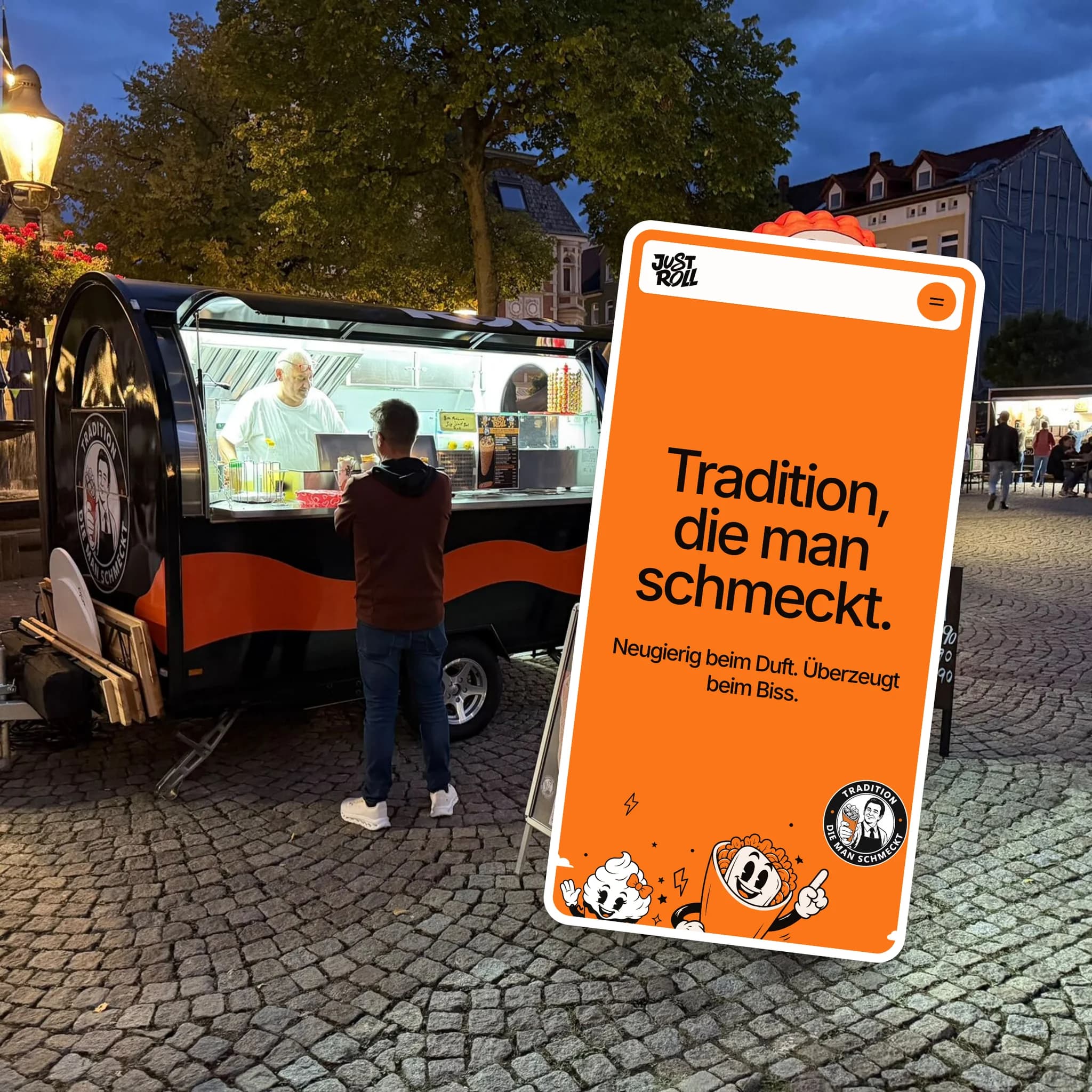 The trailer lit up at an evening market, with the home page on a phone stuck over it like a sticker.